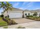 Well-maintained one-story home boasting a paver driveway, two-car garage and lovely lawn at 17728 Silverspur Dr, Punta Gorda, FL 33982