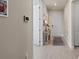 View of neutral-toned hallway with tiled floors, leading to the front door of the home at 17728 Silverspur Dr, Punta Gorda, FL 33982