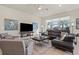 Bright living room featuring modern furniture, a large window, and tile flooring at 17728 Silverspur Dr, Punta Gorda, FL 33982