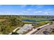 An elevated view shows a sports complex featuring a track, football field, and skate park, surrounded by lush greenery at 17728 Silverspur Dr, Punta Gorda, FL 33982