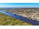 An aerial view showing a scenic waterfront community along a canal at 18502 Arapahoe Cir, Port Charlotte, FL 33948