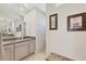 Modern bathroom featuring granite counters, double sinks, and a tiled walk-in shower at 18502 Arapahoe Cir, Port Charlotte, FL 33948