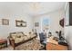 Bedroom featuring neutral colors, a ceiling fan, and a sofa for relaxing at 18502 Arapahoe Cir, Port Charlotte, FL 33948