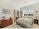 Cozy bedroom featuring a ceiling fan, a bookshelf and neutral tones at 18502 Arapahoe Cir, Port Charlotte, FL 33948