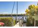 Waterfront property featuring a dock with a sailboat and tropical landscaping at 18502 Arapahoe Cir, Port Charlotte, FL 33948