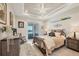 Tranquil bedroom offers a serene retreat with a tray ceiling, recessed lighting, and a sliding door to the patio at 18502 Arapahoe Cir, Port Charlotte, FL 33948