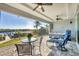 Outdoor patio area with comfortable seating, ceiling fans, and waterfront views at 18502 Arapahoe Cir, Port Charlotte, FL 33948