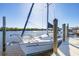 Dockside sailboat with a white hull and wooden pier under a bright blue sky at 18502 Arapahoe Cir, Port Charlotte, FL 33948