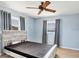 Bedroom featuring a ceiling fan, two windows, and natural light at 1906 Mississippi Ave, Englewood, FL 34224