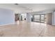 Bright living space featuring tile flooring, a ceiling fan, and an open flow to kitchen at 1906 Mississippi Ave, Englewood, FL 34224