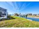 Backyard featuring canal access, boat lift, grassy area, and screened-in porch at 1922 Michigan Ave, Englewood, FL 34224