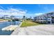 Backyard featuring canal access, boat lift, grassy area, and screened-in porch at 1922 Michigan Ave, Englewood, FL 34224