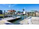 Dock featuring boat lift, canal access, seawall, and nearby homes at 1922 Michigan Ave, Englewood, FL 34224