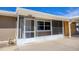 Enclosed entryway with storm door, screens, and a view of the address number above at 1922 Michigan Ave, Englewood, FL 34224