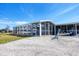 Home exterior showing screened-in porch and gravel drive at 1922 Michigan Ave, Englewood, FL 34224