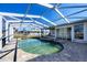 View of enclosed pool featuring paved deck with a clear view of the nearby canal at 1922 Michigan Ave, Englewood, FL 34224