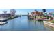 Waterfront view of the canal, boat lift, dock and surrounding houses at 1922 Michigan Ave, Englewood, FL 34224