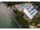 An aerial view of a luxurious waterfront home featuring a private dock and sparkling swimming pool at 2255 N Beach Rd # 12, Englewood, FL 34223