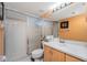 Bathroom featuring a glass shower, neutral tile, and orange accent walls at 2255 N Beach Rd # 12, Englewood, FL 34223