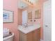 Bright bathroom with vanity, and mirror, features colorful walls at 2255 N Beach Rd # 12, Englewood, FL 34223