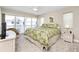 Large main bedroom features bright windows, carpet, and floral bedding at 2255 N Beach Rd # 12, Englewood, FL 34223