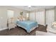 Comfortable bedroom with wood flooring and a cozy wicker side table at 2255 N Beach Rd # 12, Englewood, FL 34223