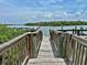 A view from a wooden dock, with a clear view of the blue-green water, perfect for boating at 2255 N Beach Rd # 12, Englewood, FL 34223