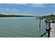 Dock with a serene water view surrounded by trees and greenery at 2255 N Beach Rd # 12, Englewood, FL 34223