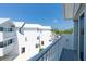 Balcony view of white condos with silver roofs, complemented by sunny blue skies at 2255 N Beach Rd # 12, Englewood, FL 34223