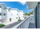 View of the exterior of white condo buildings with silver roofs, seen from a balcony at 2255 N Beach Rd # 12, Englewood, FL 34223