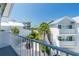 Exterior view of white condos with palm trees, captured from a balcony on a sunny day at 2255 N Beach Rd # 12, Englewood, FL 34223