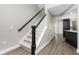 Hallway with stairs leading to the upper level, features wood-look floors and neutral paint at 2255 N Beach Rd # 12, Englewood, FL 34223