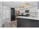 Contemporary kitchen featuring stainless steel appliances, two-tone cabinets, and quartz countertops with wood floor at 2255 N Beach Rd # 12, Englewood, FL 34223