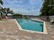 Outdoor pool area with lounge chairs surrounded by tropical vegetation at 2255 N Beach Rd # 12, Englewood, FL 34223