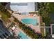 Aerial close up of a shared community pool with lounge seating and lush tropical landscaping at 2255 N Beach Rd # 12, Englewood, FL 34223