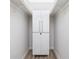 White closet with overhead shelving and a storage cabinet at 2375 N Beach Rd # 2B, Englewood, FL 34223