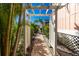 Inviting entryway with a charming pergola and lush landscaping at 2375 N Beach Rd # 2B, Englewood, FL 34223