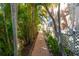 Brick pathway bordered by tropical foliage leading through the property at 2375 N Beach Rd # 2B, Englewood, FL 34223