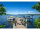 Expansive waterfront dock with benches and a ladder for easy water access at 2375 N Beach Rd # 2B, Englewood, FL 34223