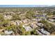 Aerial view of homes in a quiet community with lush green trees at 2657 Tusket Ave, North Port, FL 34286