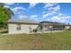 View of the home's backyard with a screened-in pool at 2657 Tusket Ave, North Port, FL 34286