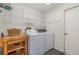 Well-lit laundry room with washer, dryer, and ample storage shelves at 2657 Tusket Ave, North Port, FL 34286