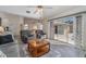 Comfortable living room featuring tile floors, slider to screened lanai and view of the Kitchen at 2657 Tusket Ave, North Port, FL 34286