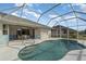 Backyard features a screened-in pool and patio area, ideal for outdoor living at 2657 Tusket Ave, North Port, FL 34286