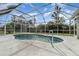 Screened-in pool area with a kidney-shaped pool for outdoor enjoyment at 2657 Tusket Ave, North Port, FL 34286