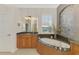 Bright bathroom featuring granite countertops, garden tub, and a large window for natural light at 2660 Sable Palm Way, Port Charlotte, FL 33953