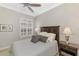 Bedroom featuring a full size bed, ceiling fan, and natural light from shuttered window at 2660 Sable Palm Way, Port Charlotte, FL 33953