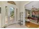 Bright foyer featuring tile flooring and an adjacent home office with custom built-ins at 2660 Sable Palm Way, Port Charlotte, FL 33953