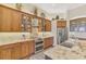 Close-up of kitchen with stainless steel range and hood, custom cabinetry, stone countertops, and stylish backsplash at 2660 Sable Palm Way, Port Charlotte, FL 33953