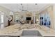 Kitchen island featuring granite countertops, a stainless steel farmhouse sink, and a view into the living room at 2660 Sable Palm Way, Port Charlotte, FL 33953